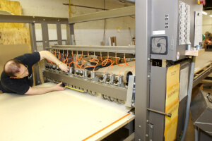 Technician Adjusting a Slitter Laminator Machine
