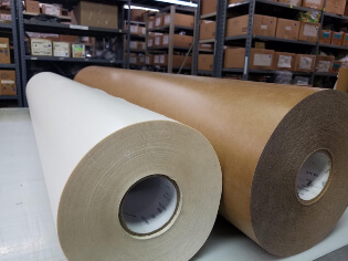 Two large rolls of PSA material at Web Seal in Rochester NY